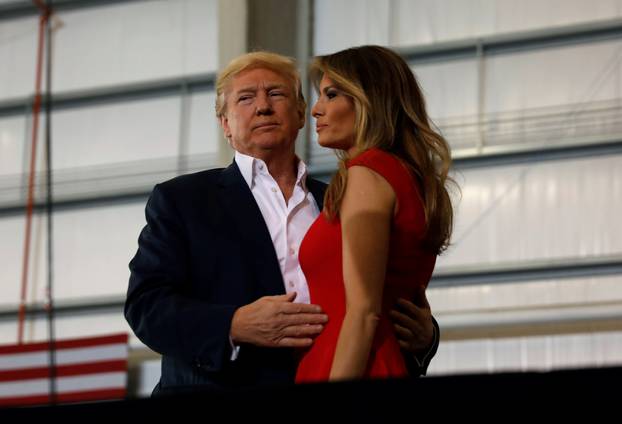 U.S. President Donald Trump hugs his wife Melania during a "Make America Great Again" rally at Orlando Melbourne International Airport in Melbourne, Florida, U.S.