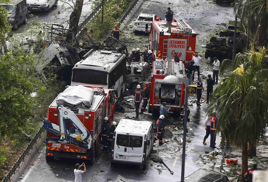 Fire engines stand beside a Turkish police bus which was targeted in a bomb attack in a central Istanbul district