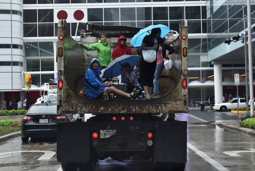 Evacuees are transported to the George R. Brown Convention Center after Hurricane Harvey inundated the Texas Gulf coast with rain causing widespread flooding