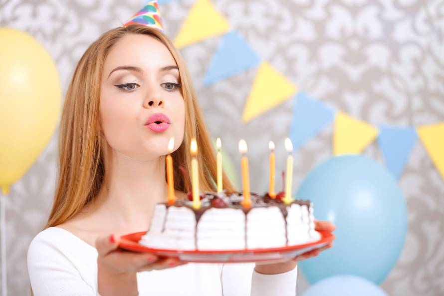 Happy girl and her birthday cake