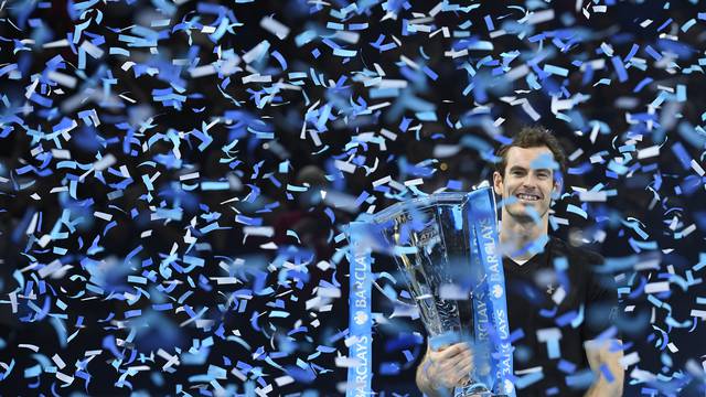 Great Britain's Andy Murray celebrates winning the final against Serbia's Novak Djokovic with the ATP World Tour Finals trophy