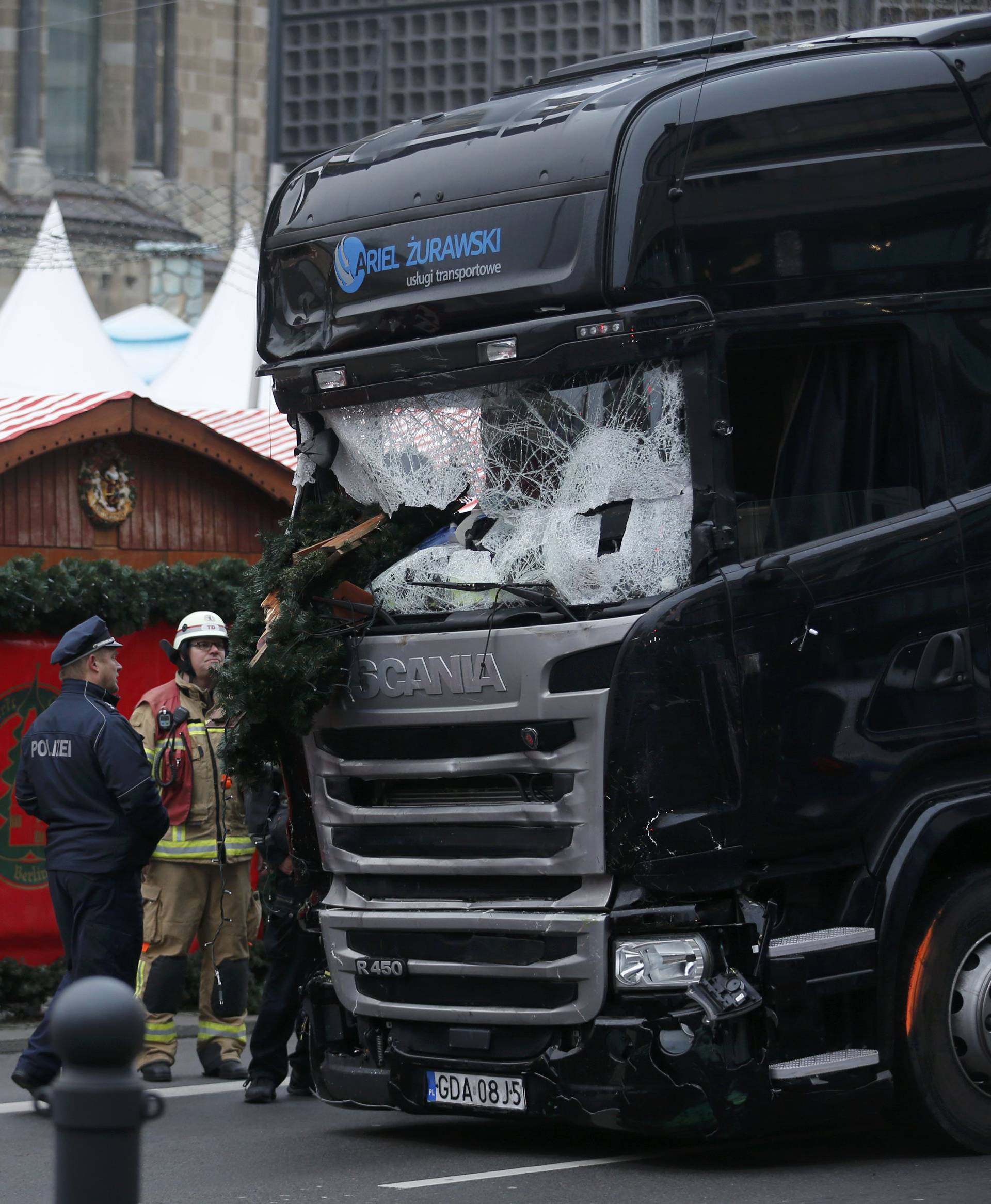 Police stand in front of the truck which ploughed last night into a crowded Christmas market in the German capital Berlin