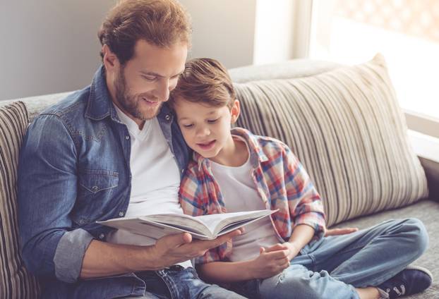 Father,And,Son,Are,Reading,A,Book,And,Smiling,While
