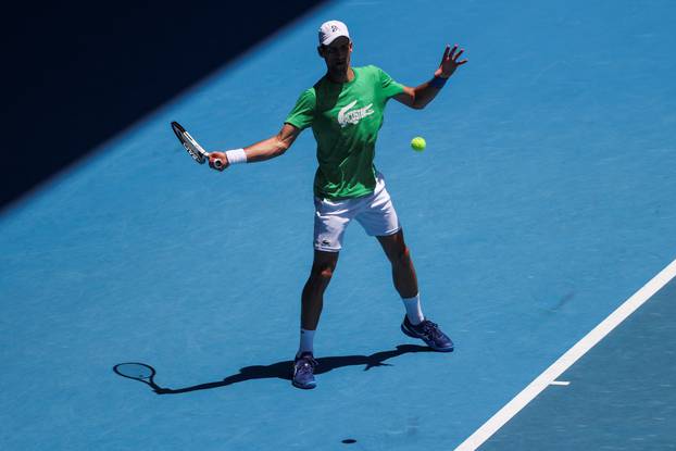 Serbian tennis player Novak Djokovic practices at Melbourne Park as questions remain over the legal battle regarding his visa to play in the Australian Open