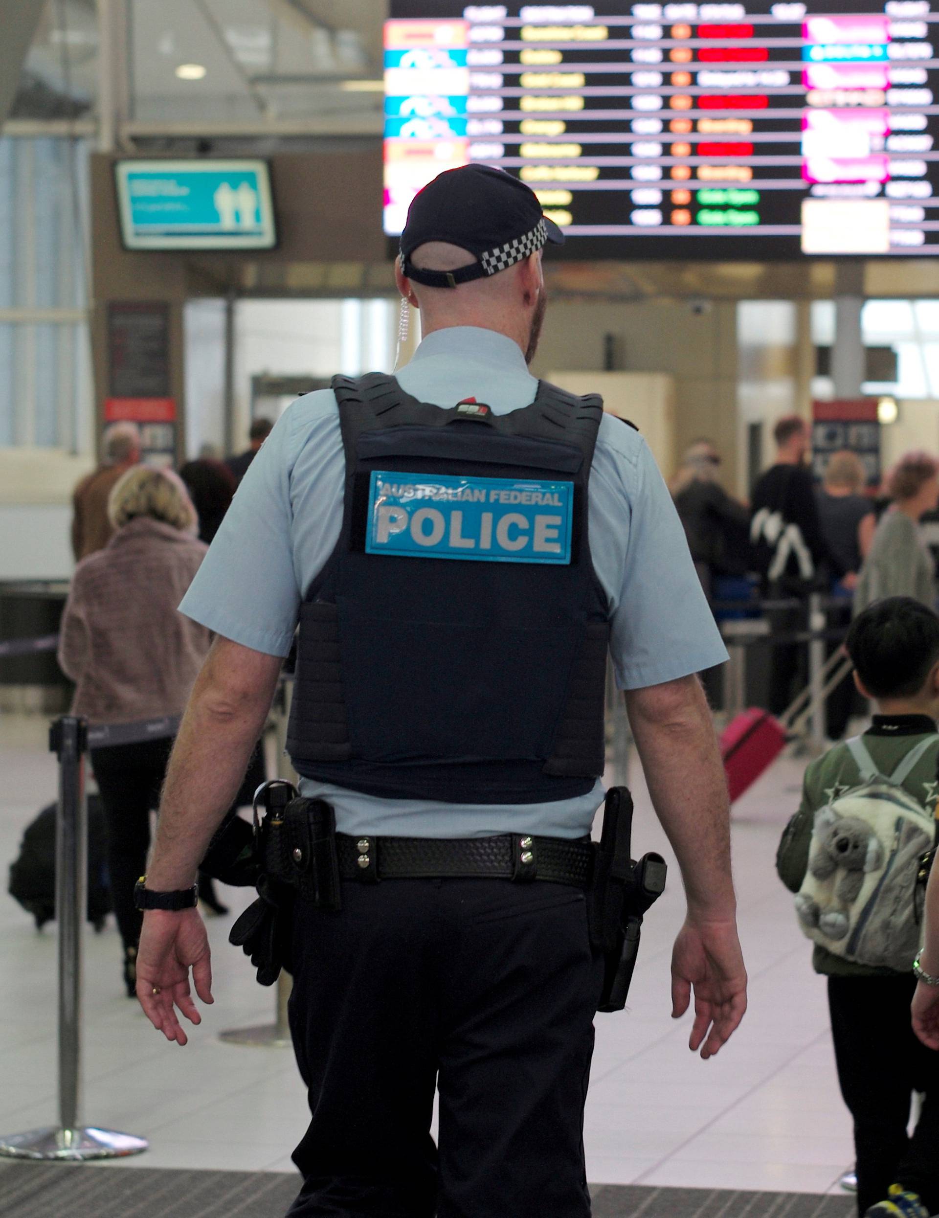 Australia Federal Police officers patrol the security lines at Sydney's Domestic Airport in Australia