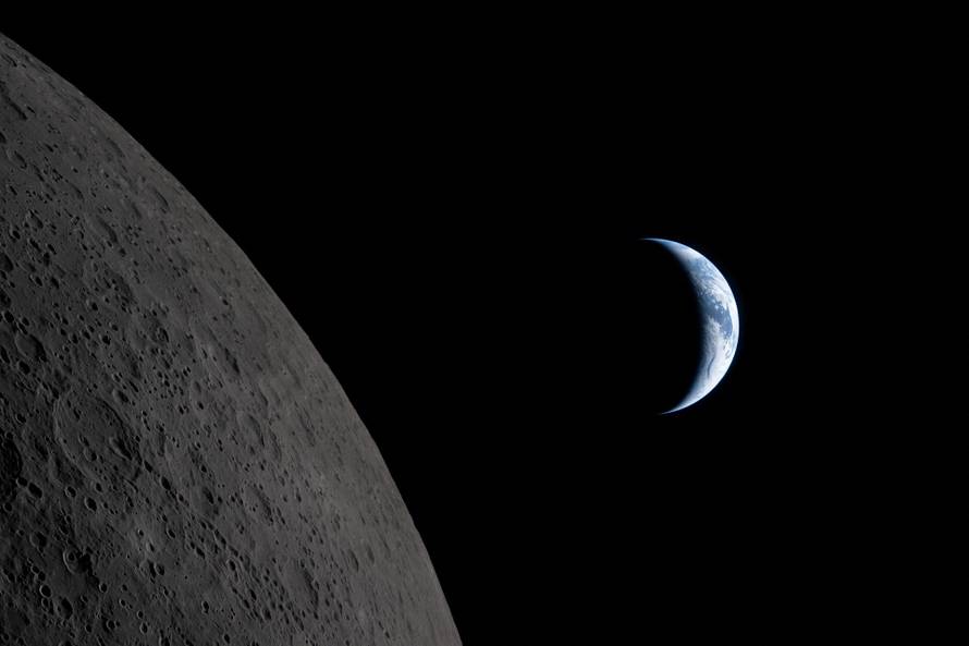 Earth passing behind the Moon as photographed through the Orion spacecraft window