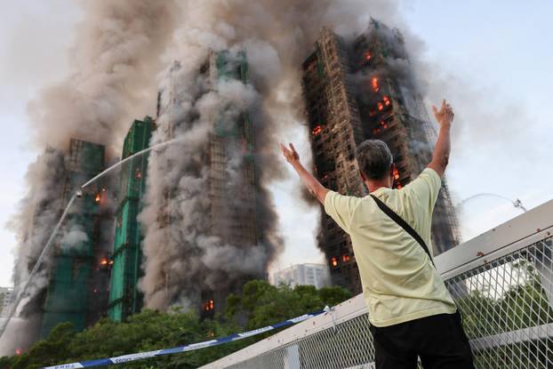 Flames engulf bamboo scaffolding across multiple buildings at Wang Fuk Court housing estate, in Tai Po