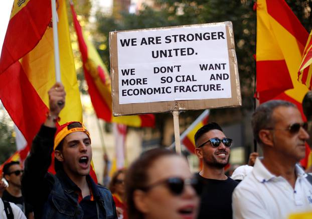 A man carries a placard in English during a pro-union demonstration organised by the Catalan Civil Society organisation in Barcelona