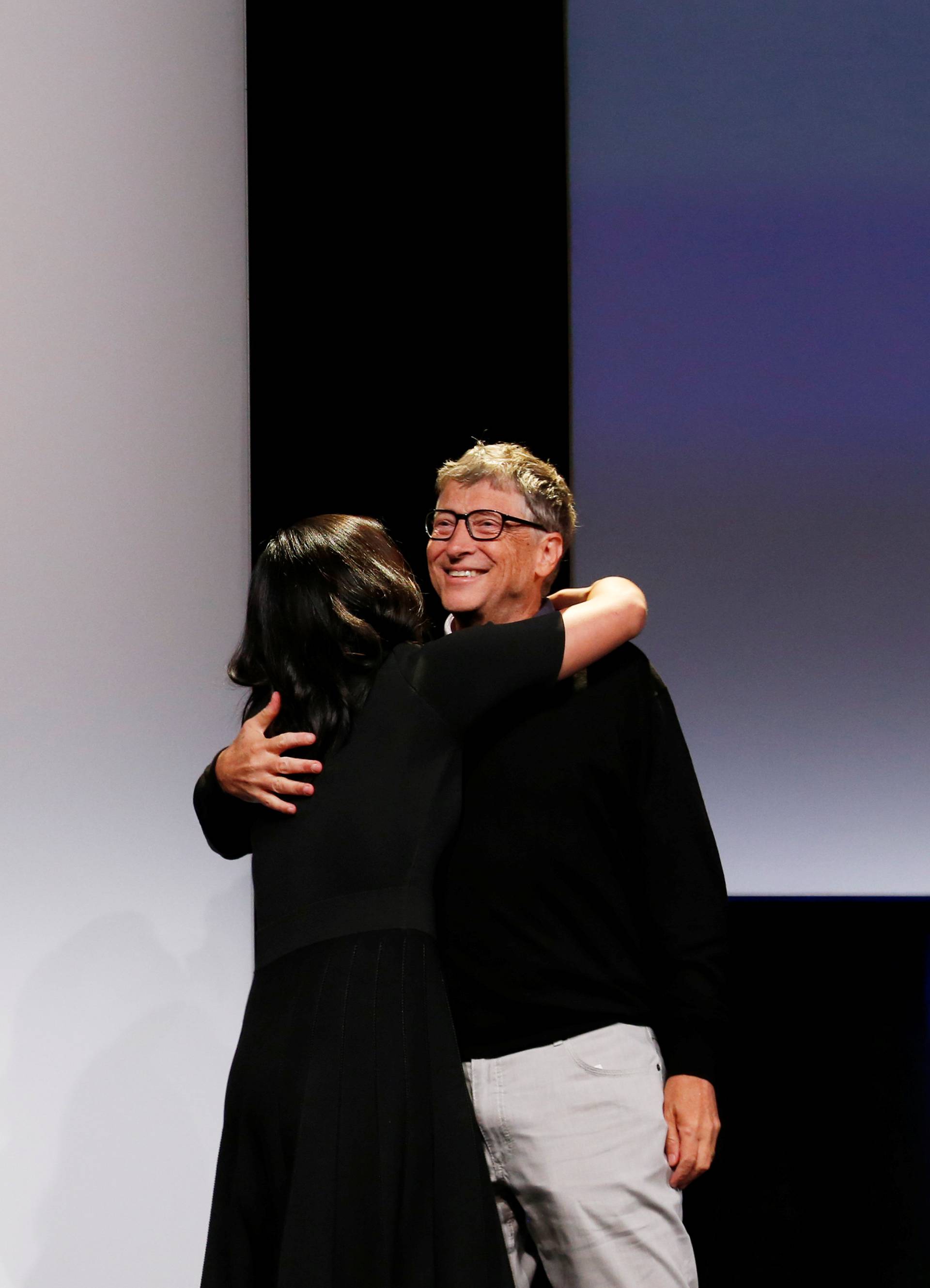 Philanthropist Bill Gates embraces Pricilla Chan during an announcement of the Chan Zuckerberg Initiative to cure all diseases by the end of the century during a news conference at UCSF Mission Bay in San Francisco, Califor