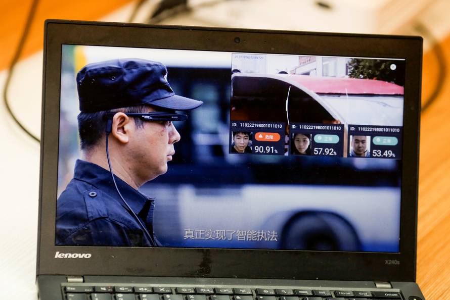 A promotion video shows an actor wearing LLVision facial recognition smart glasses during a demonstration at the company's office in Beijing