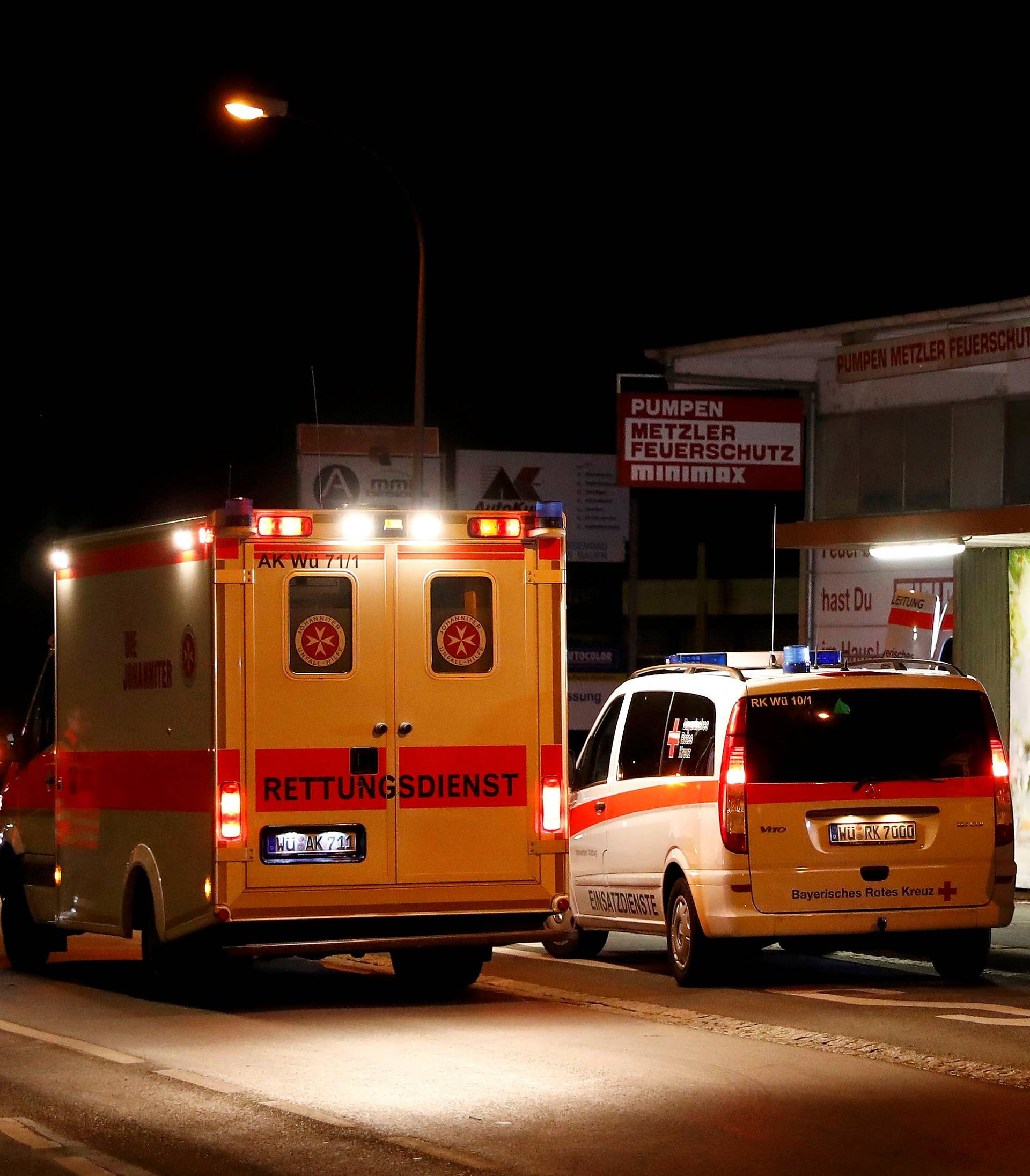 German emergency services workers work in the area where a man with an axe attacked passengers on a train near Wuerzburg