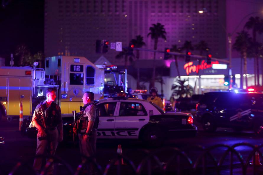 Las Vegas Metro Police officers confer near a staging area in the intersection of Tropicana Avenue and Las Vegas Boulevard South after a mass shooting at a music festival on the Las Vegas Strip in Las Vegas