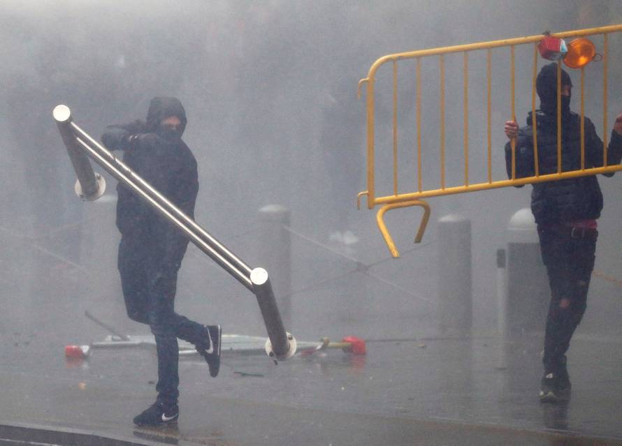 Far-right supporters throw barricades during a protest against Marrakesh Migration Pact in Brussels