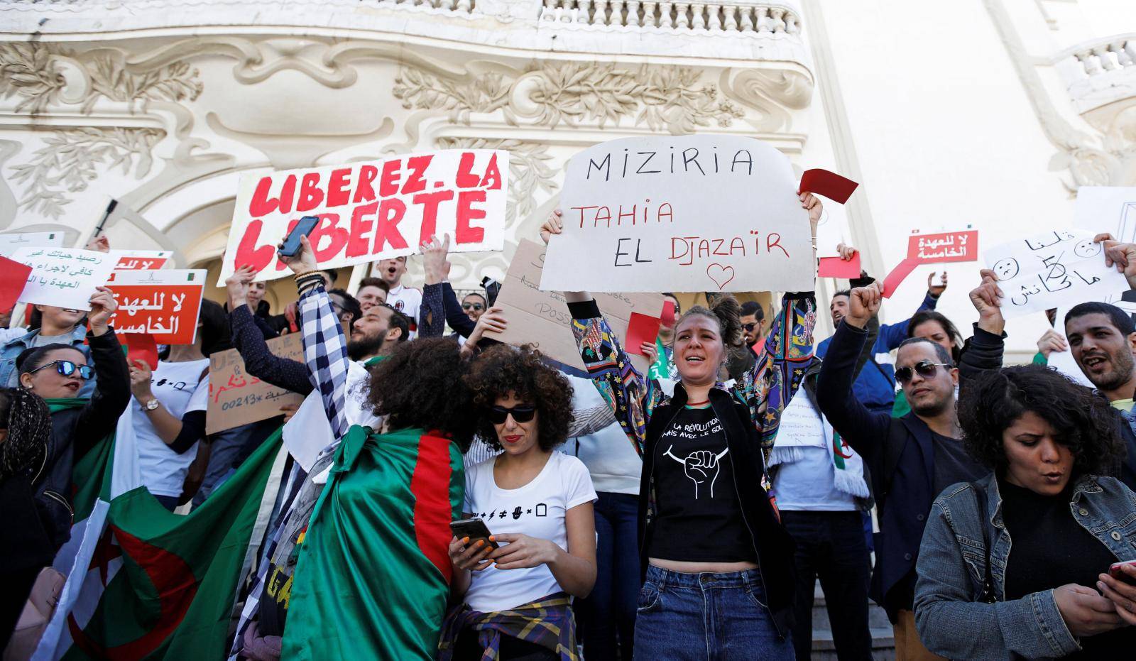 People take part in a protest against Algerian President Abdelaziz Bouteflika seeking a fifth term in a presidential election set for April 18, in Tunis