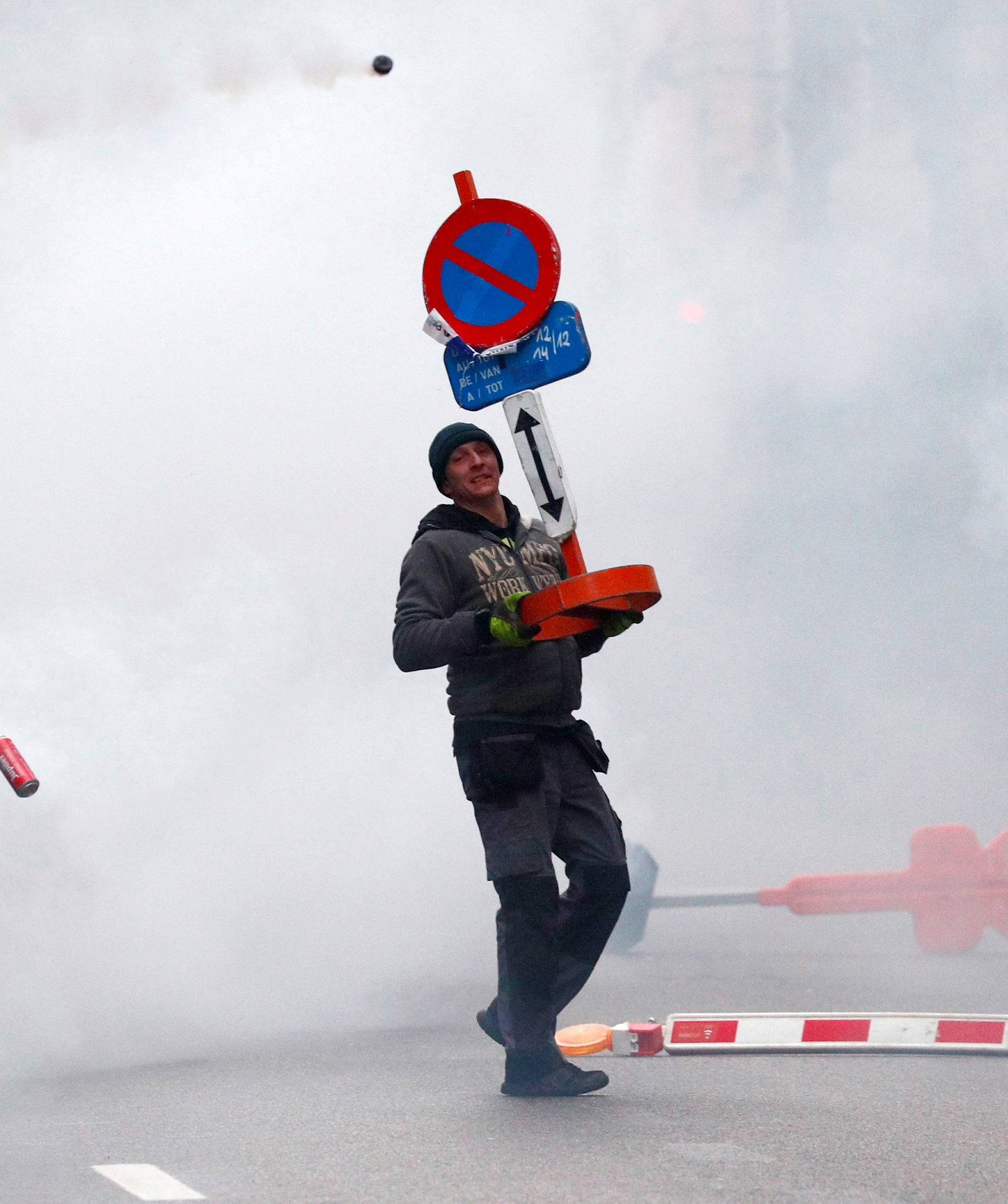 Far-right supporter throws a small container during a protest against Marrakesh Migration Pact in Brussels