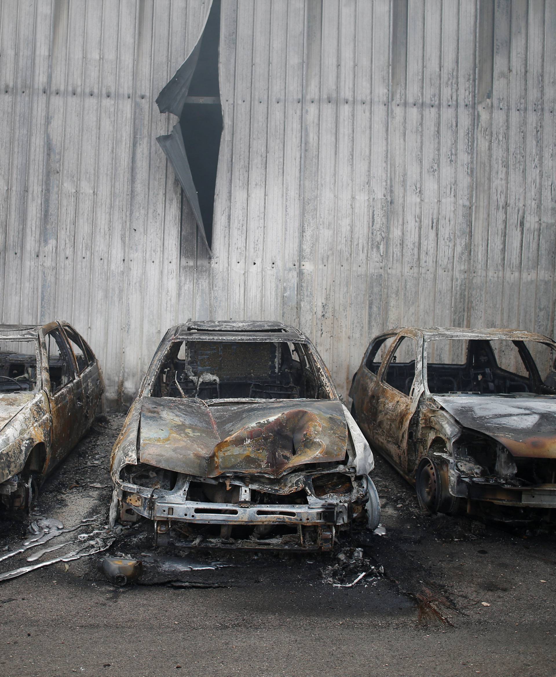 Burnt vehicles are seen after a forest fire in Miro, near Penacova