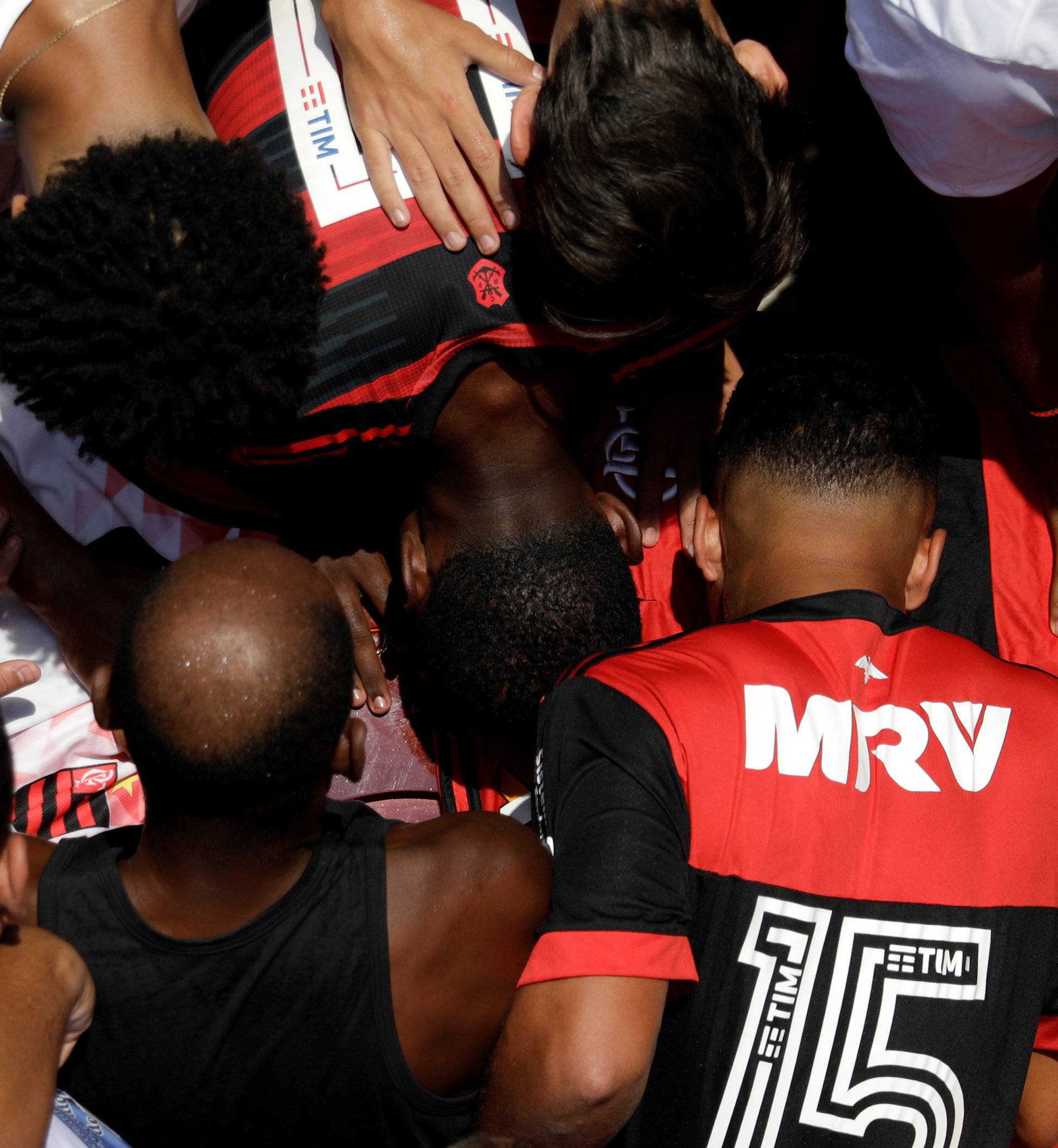 Relatives and friends of Christian Esmerio react during his burial after a deadly fire at Flamengo soccer club's training center, in Rio de Janeiro