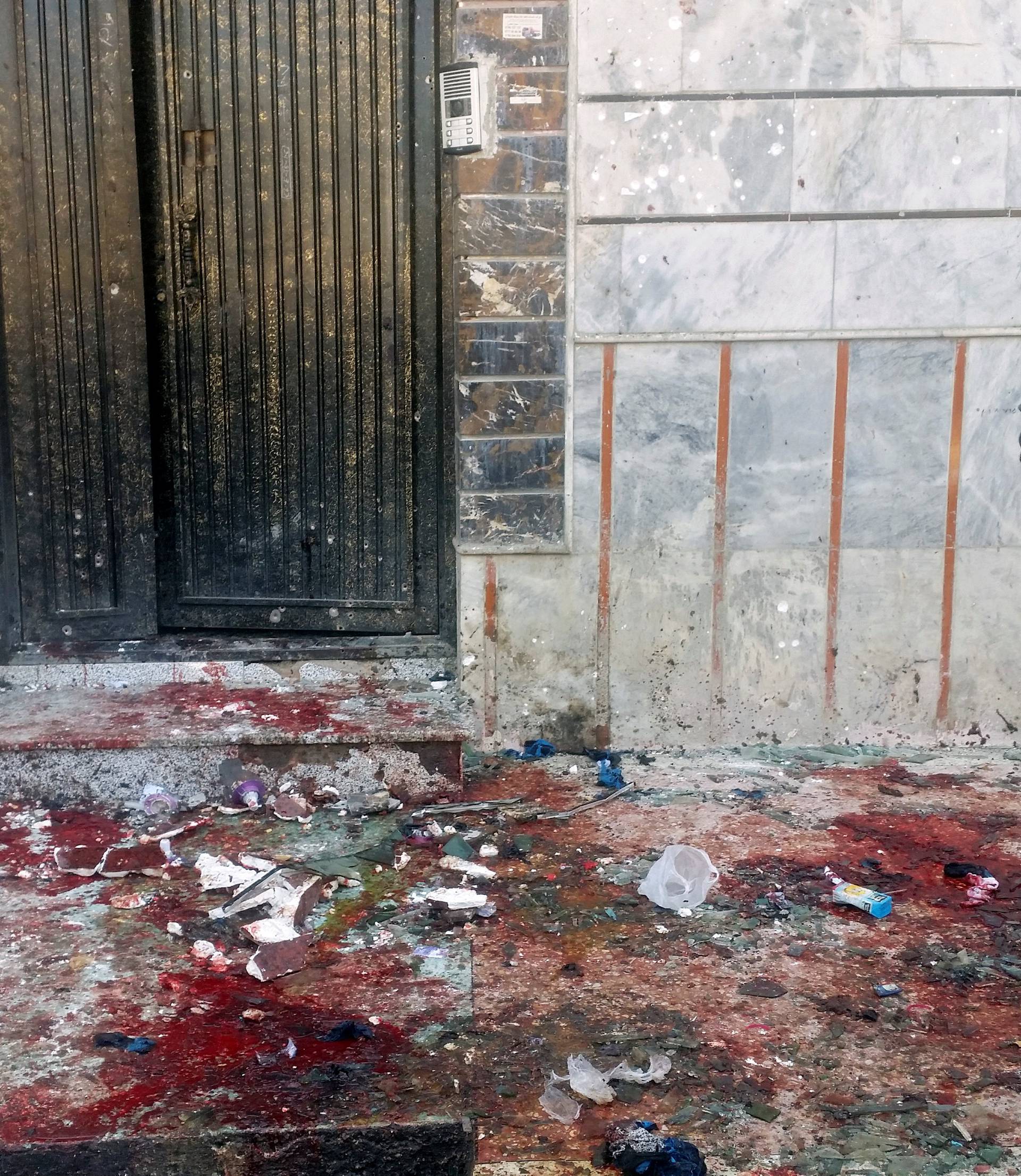 An Afghan man inspects the site of a blast in Kabul