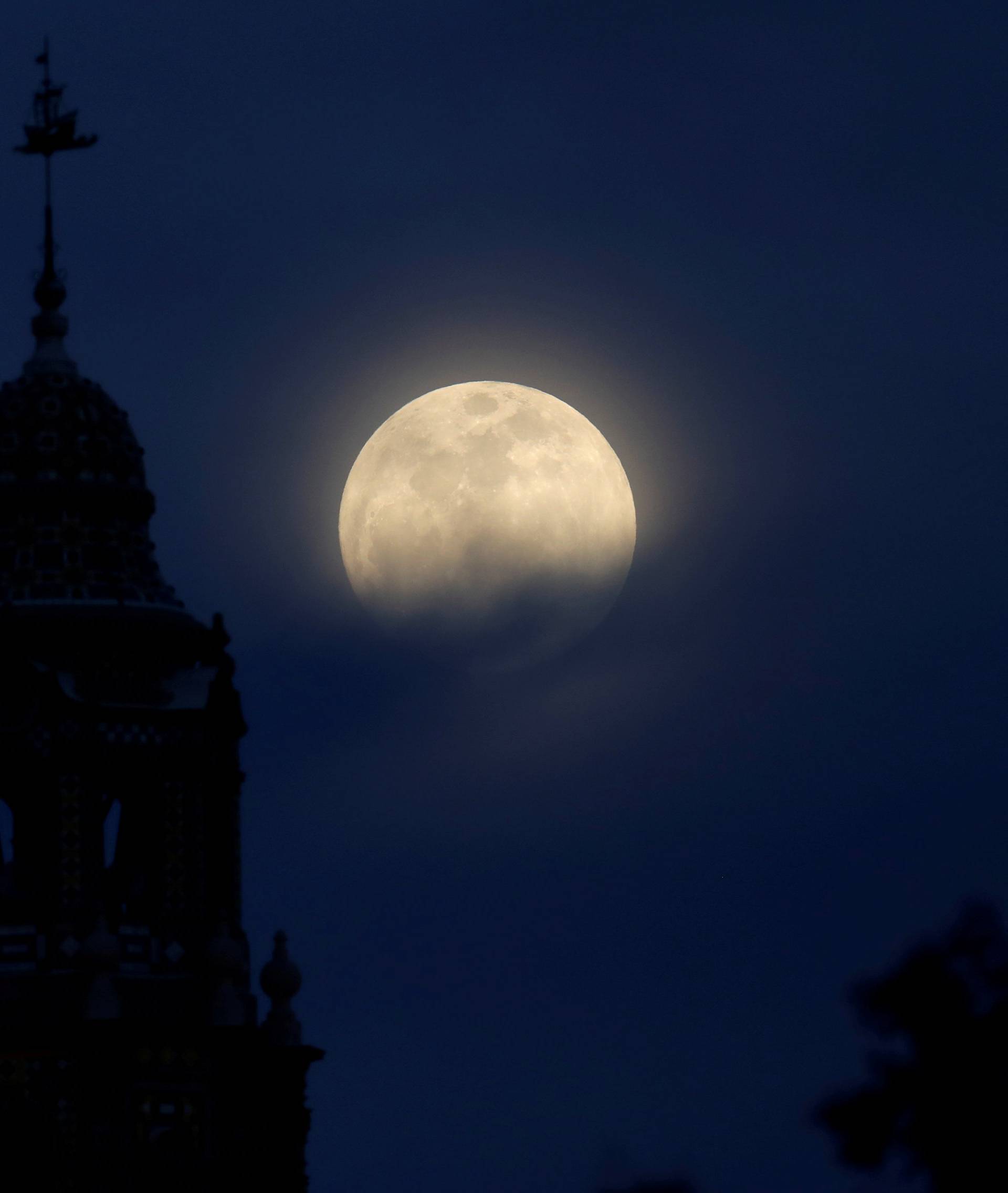 A blue moon rises over Balboa Park's California Tower in San Diego, California