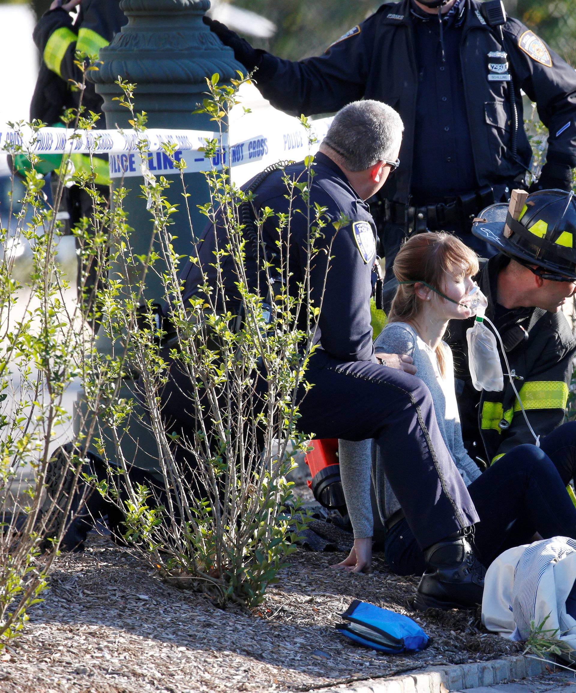 A woman is aided by first responders after sustaining injury on a bike path in lower Manhattan in New York