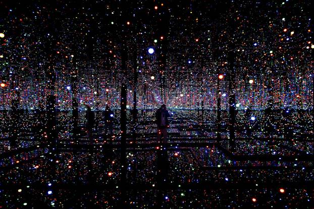 FILE PHOTO: A photographer takes pictures of an installation titled "Infinity Mirrored Room - Filled With the Brilliance of Life" by Japanese artist Yayoi Kusama during her exhibition at the Rufino Tamayo museum in Mexico City