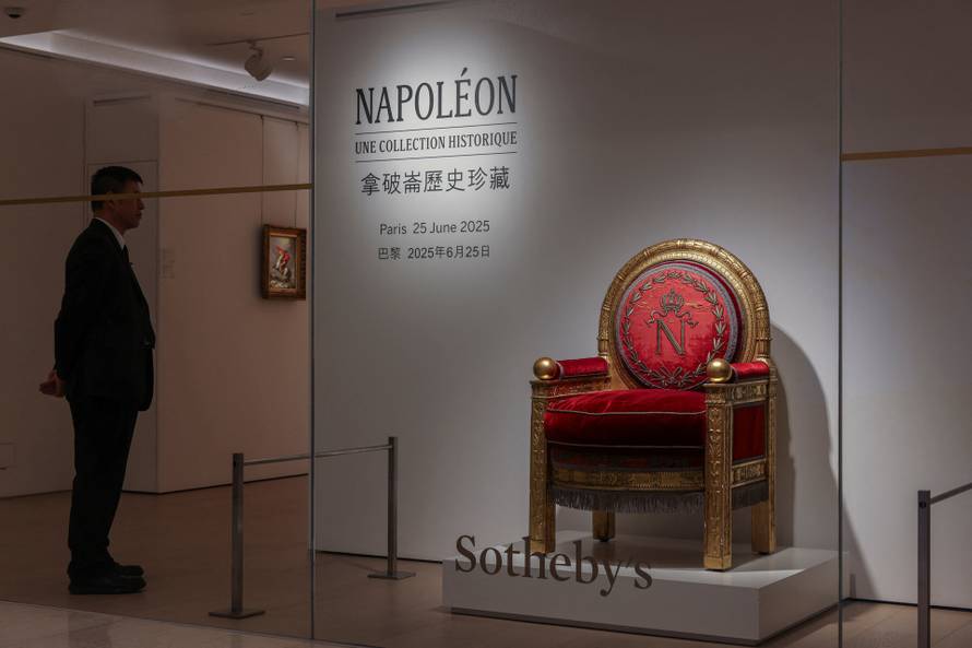 A security personnel stands next to the throne of Napoleon Bonaparte ahead of Sotheby's auction in Hong Kong