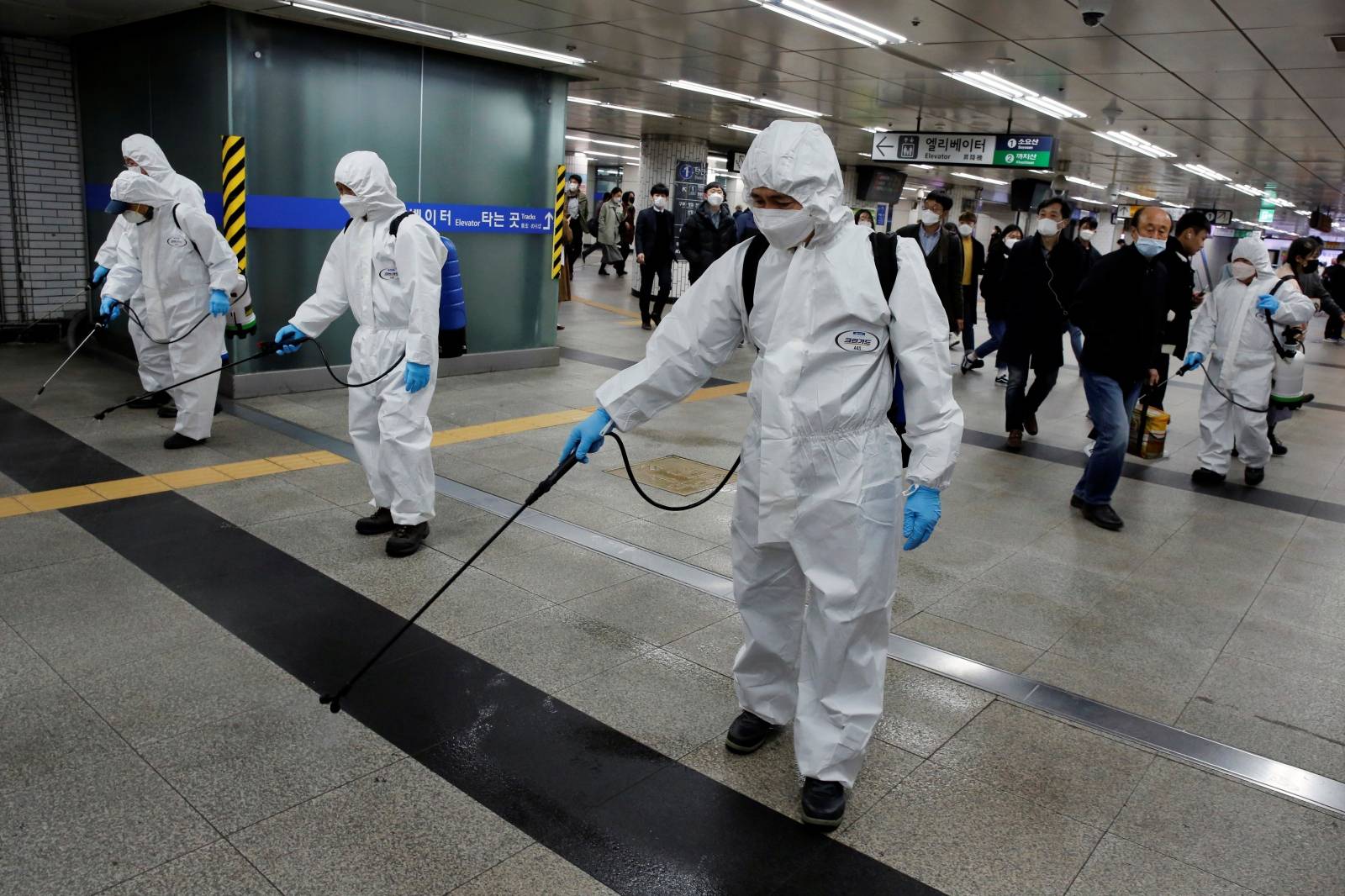 Employees from a disinfection service company sanitize a subway station amid coronavirus fears in Seoul