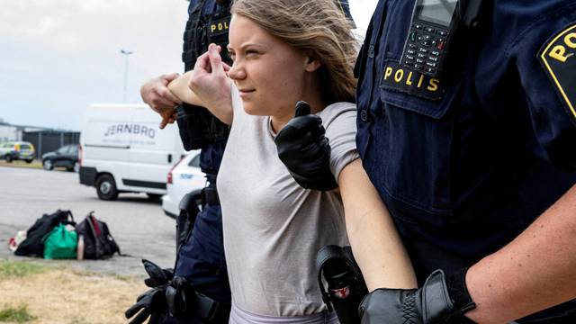 FILE PHOTO: Police remove Greta Thunberg as they move climate activists who are blocking the entrance to Oljehamnen in Malmo