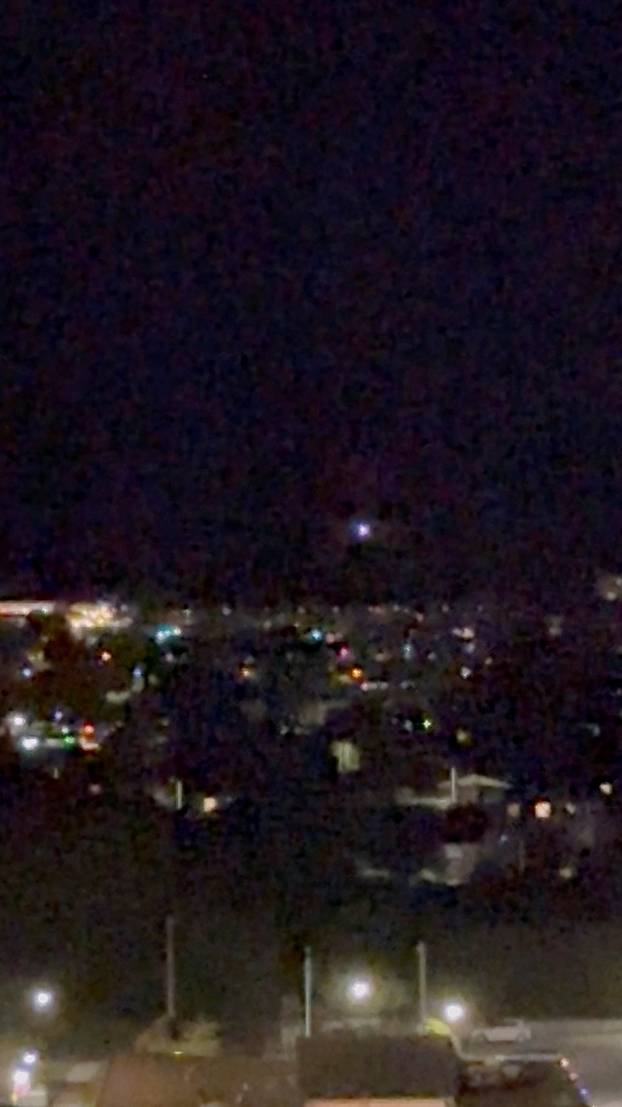 A light moves in the sky over Aalborg, amid reports of drone sightings that led to the city's airport, used for commercial and military flights, being closed due to drones in its airspace, in Aalborg