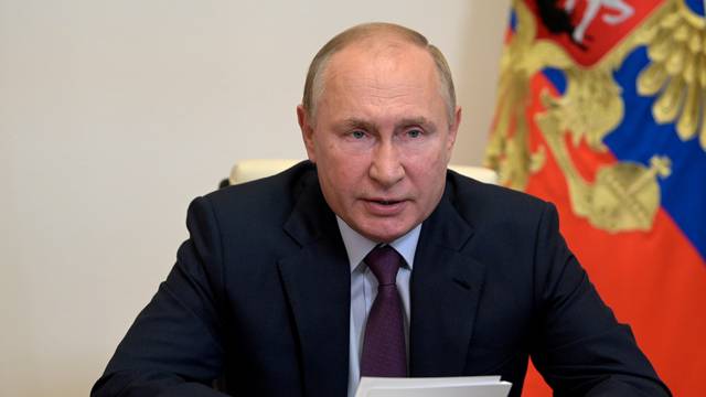 Russian President Putin chairs a meeting with members of the Security Council via a video link outside Moscow