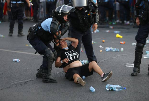 Police stand near protester during a demonstration in Bucharest