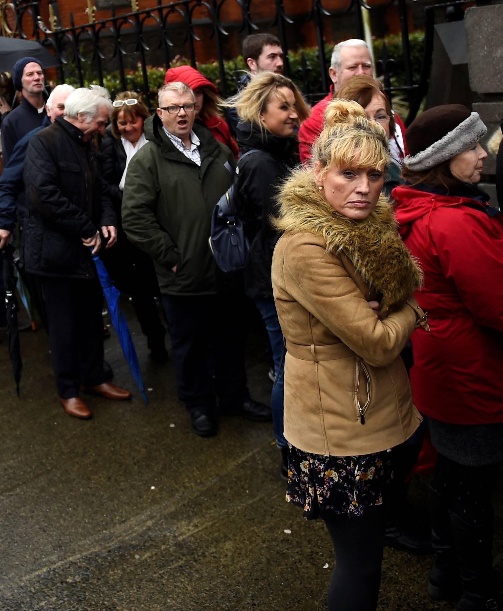 Members of the public queue to see Cranberries singer Dolores O'Riordan's coffin as it is carried into St. Joseph's Church for a public reposal in Limerick