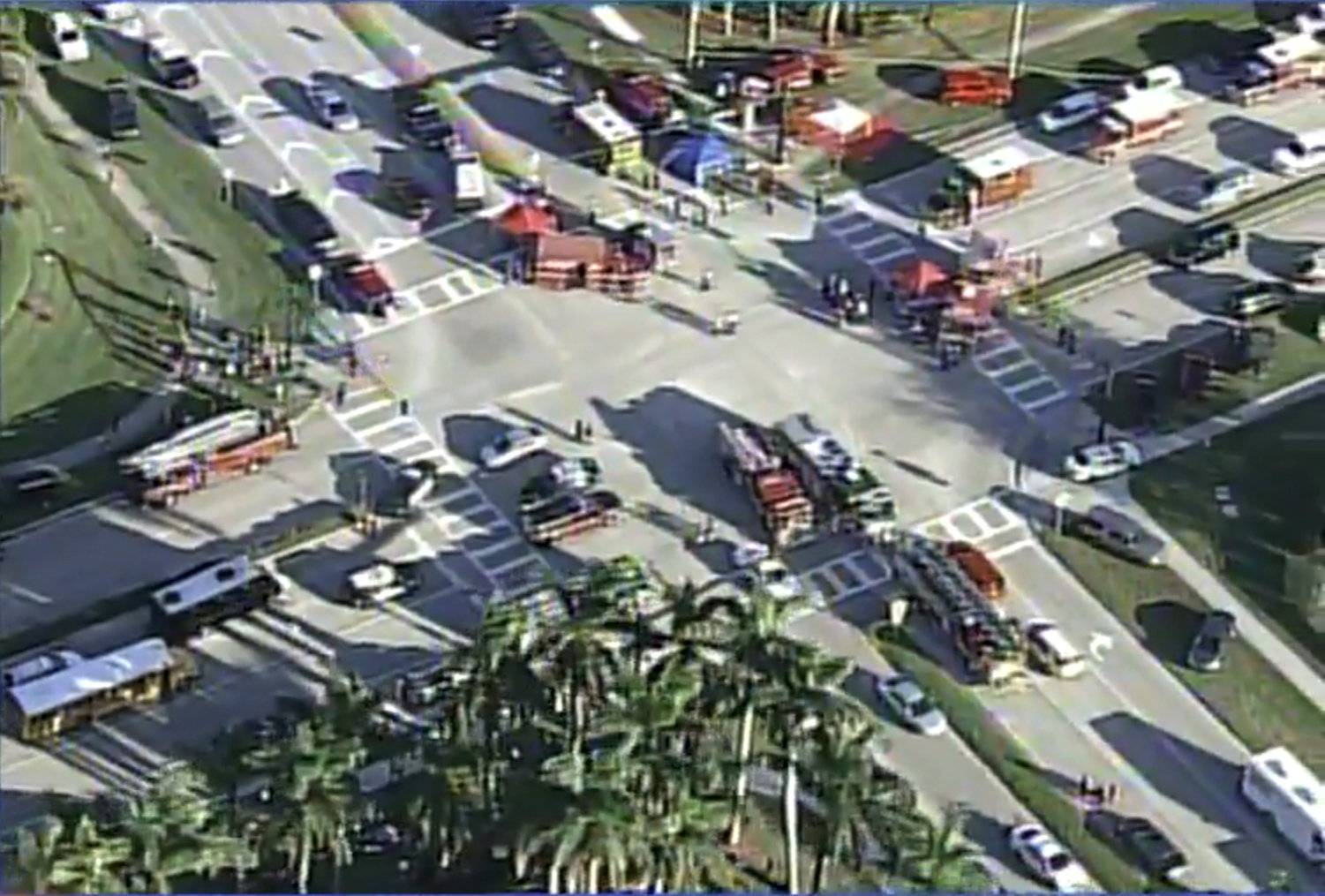 Police and rescue workers attend the scene near Marjory Stoneman Douglas High School following a shooting incident in Parkland