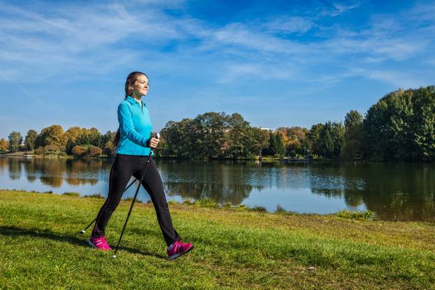 Nordic,Walking,Adventure,And,Exercising,Concept,-,Woman,Hiking,With