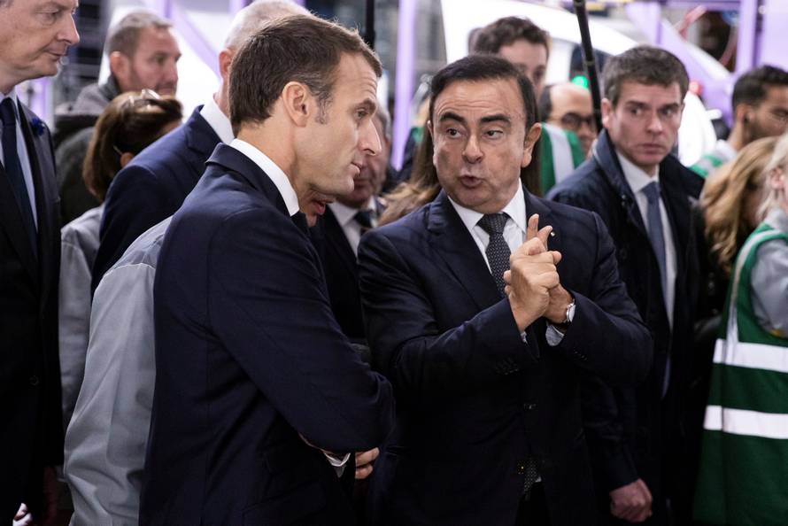 French President Emmanuel Macron discusses with Renault CEO Carlos Ghosn during a visit in the Renault factory in Maubeuge