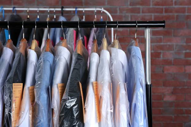Rack,Of,Clean,Clothes,Hanging,On,Hangers,At,Dry-cleaning