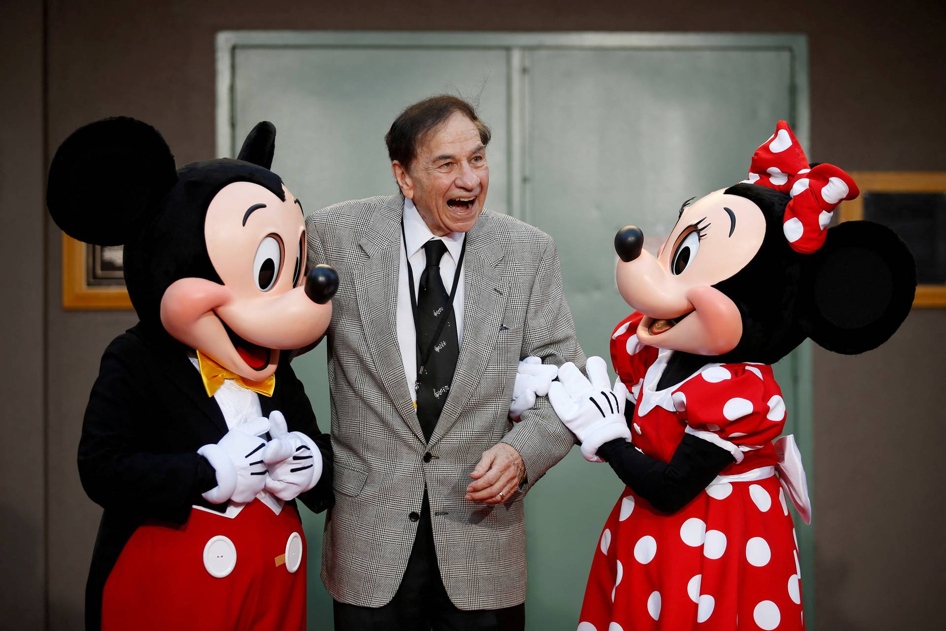 FILE PHOTO: Mickey Mouse, songwriter Richard M. Sherman and Minnie Mouse pose during a dedication of Stage A on The Walt Disney Studios