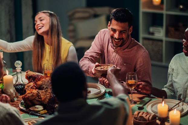 Happy,Friends,Sharing,A,Festive,Thanksgiving,Dinner,,Laughing,And,Enjoying