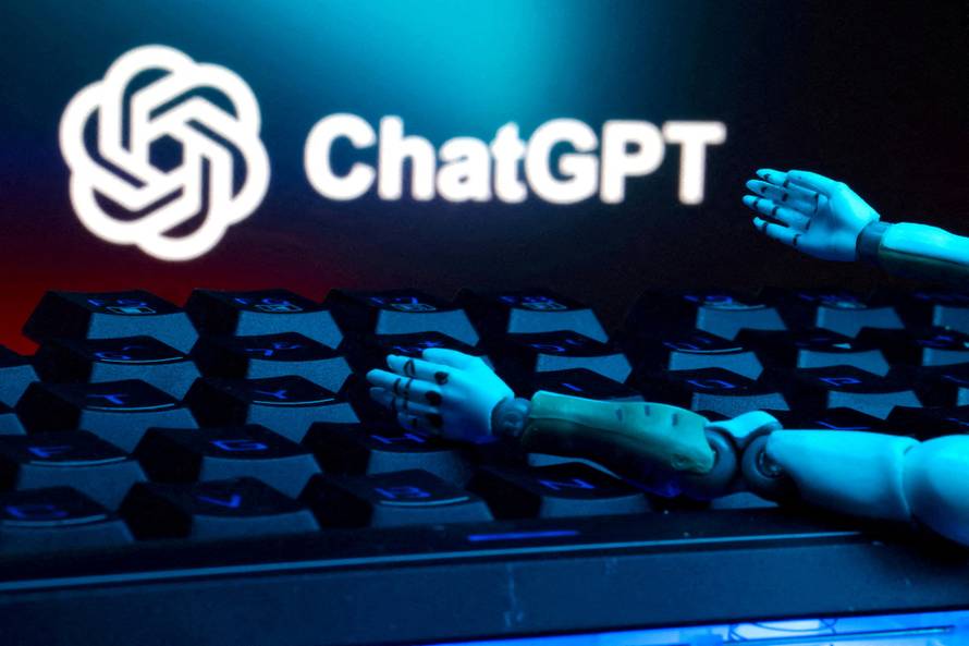 FILE PHOTO: FILE PHOTO: Illustration shows ChatGPT logo, keyboard, and robot hands