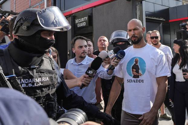 FILE PHOTO: Romanian Gendarmes escort Andrew and Tristan Tate, outside the Tate brothers' residence in Pipera