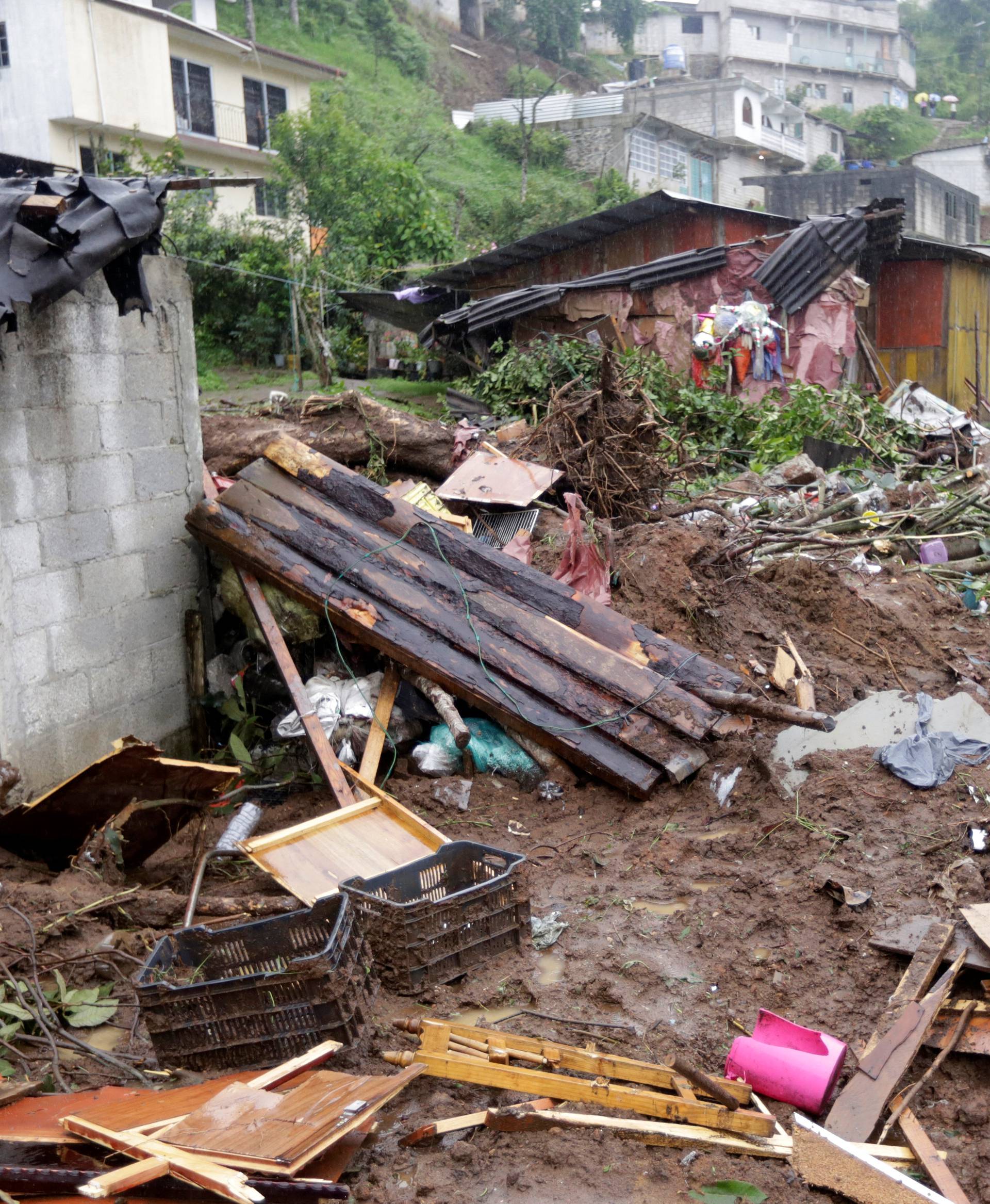 Damaged houses and debris are seen after a mudslide following heavy showers caused by the passing of Tropical Storm Earl, in the town of Huauchinango