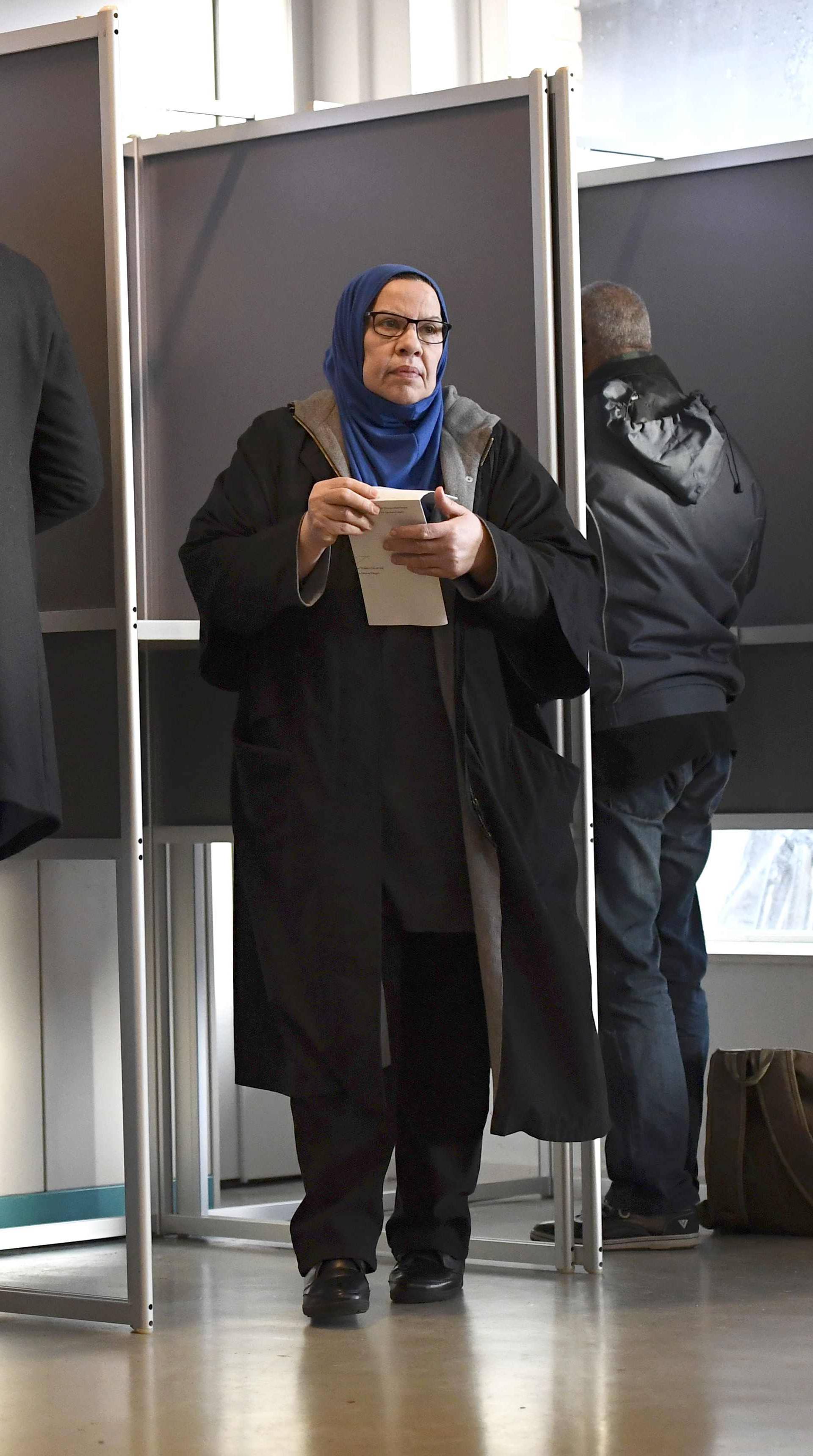 A woman votes in a polling station in the Netherlands