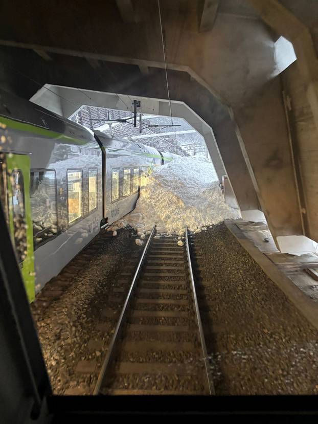 A Swiss BLS train surrounded by snow following a derailment