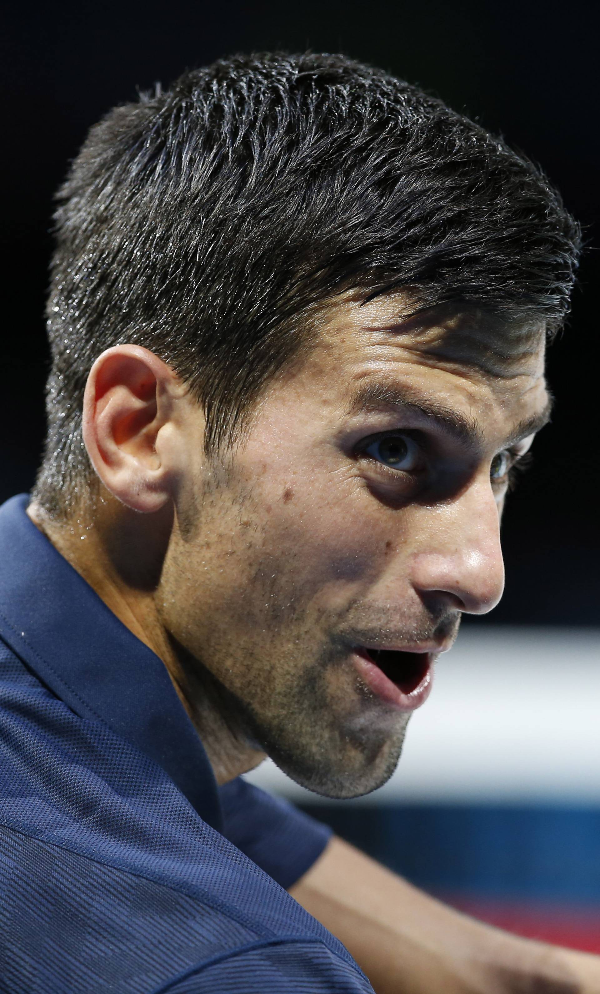 Serbia's Novak Djokovic gestures to the match referee after he was given a time violation warning during his round robin match with Belgium's David Goffin