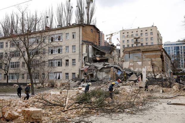 Rescuers work at the site of a building damaged by a Russian missile strike, in Kyiv