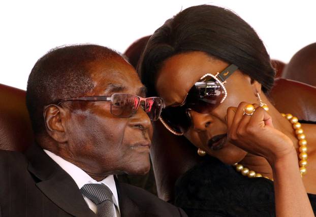 Mugabe and his wife Grace attend the burial of two independence luminaries in Harare