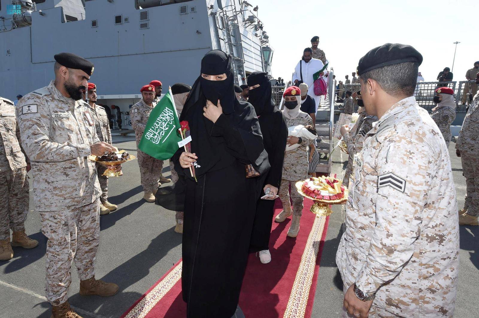 Citizens of Saudi Arabia and people from other nationalities are welcomed by Saudi Royal Navy officials as they arrive after being evacuated from Sudan at Jeddah Sea Port