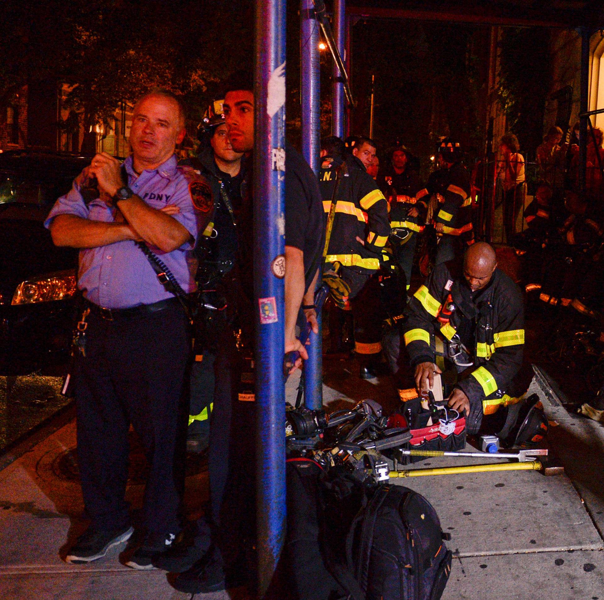 New York City firefighters stand near site of explosion in New York