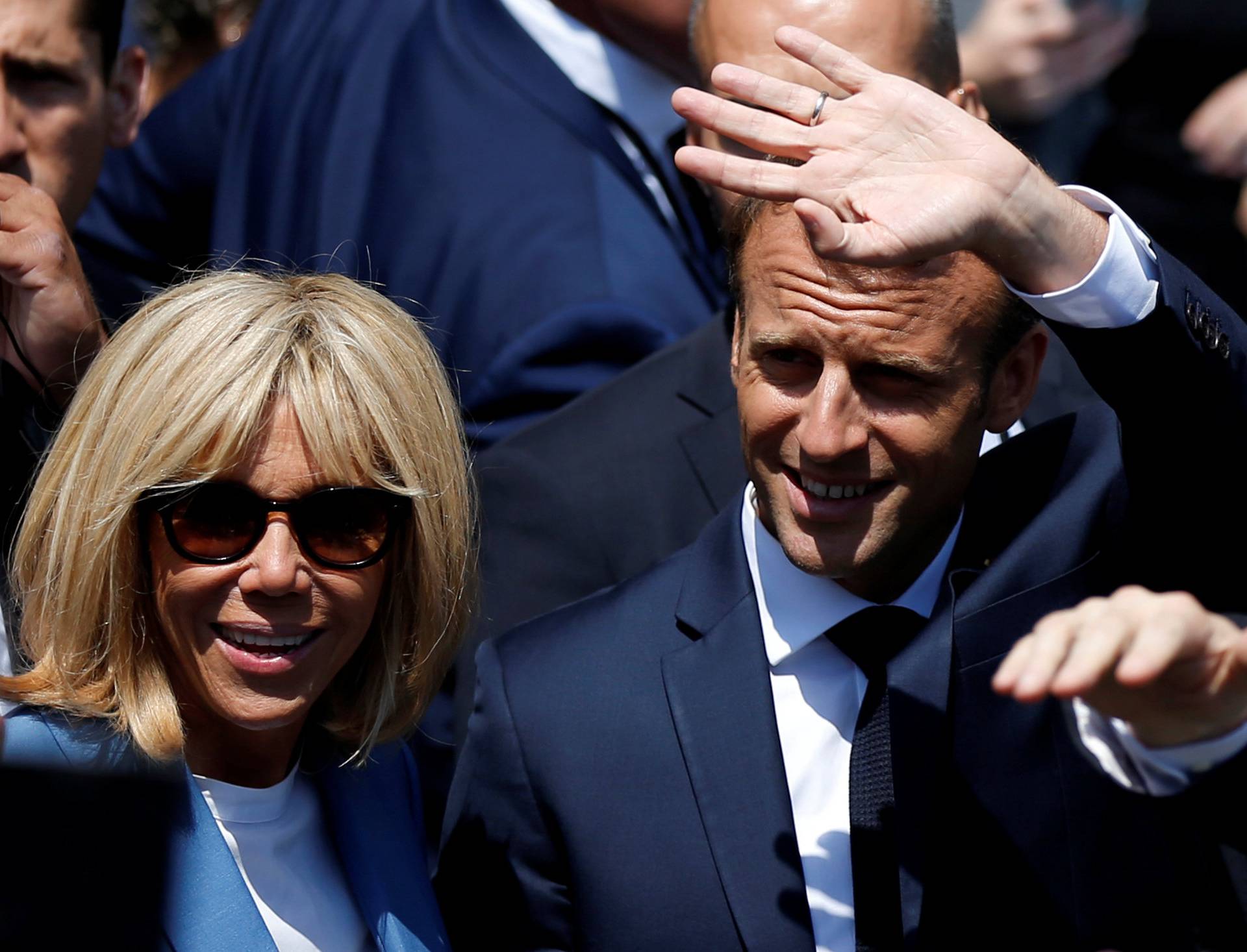 French President Emmanuel Macron waves to the crowd while touring Old Montreal with his wife Brigitte Macron in Montreal