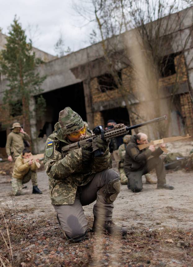 Alisa, a media relations specialist, takes part in a combat skills training conducted by the Territorial Defense Forces near Kyiv